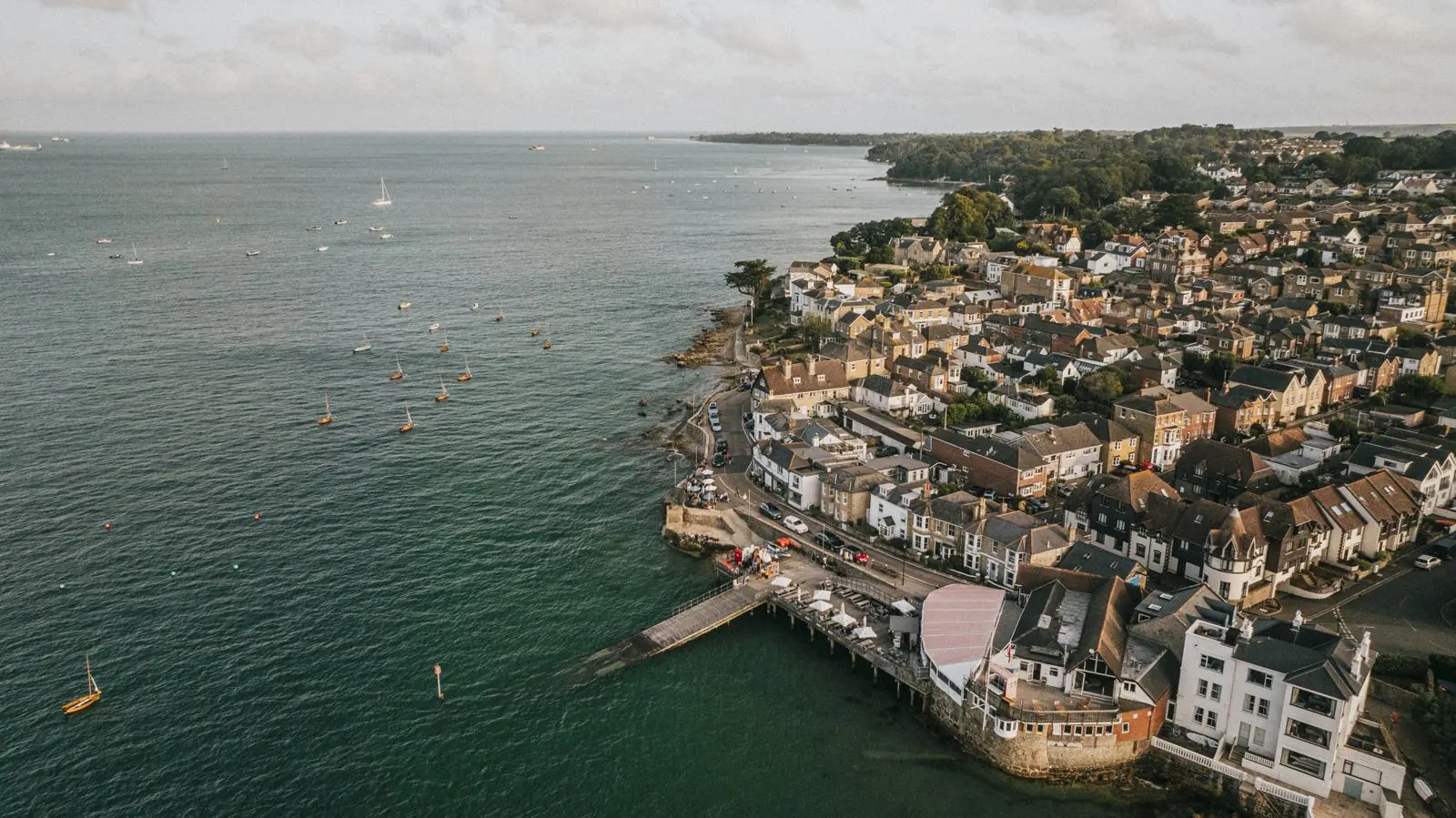 Cowes seafront and the Solent from above, boats moored off the town.